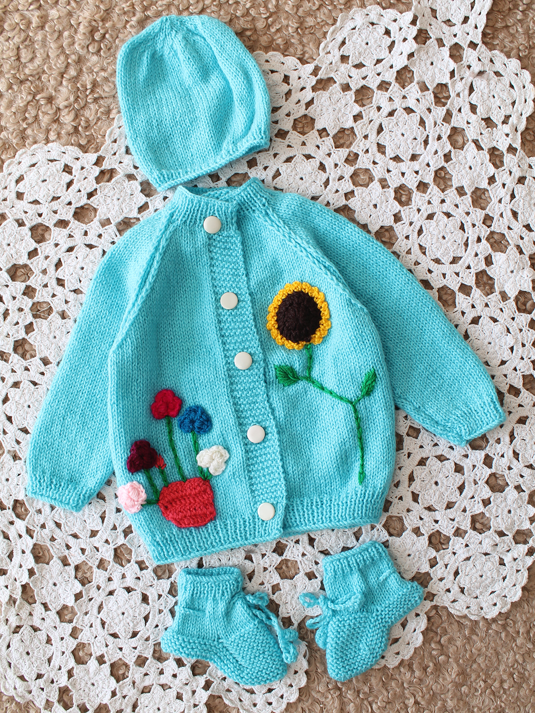 Woonie Handknitted Full Sleeves Floral Applique Cardigan Set with Cap and Booties - Light Blue