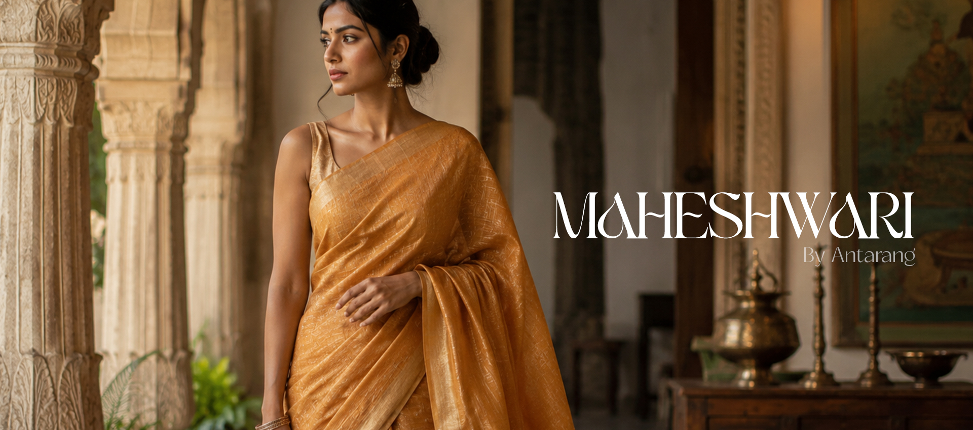 Woman wearing a traditional Maheshwari silk saree in a heritage Indian setting, showcasing handloom weaving, golden zari border and timeless craftsmanship