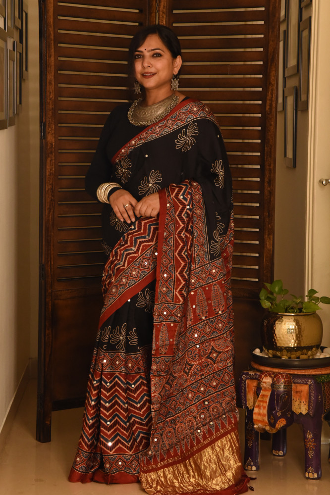Image of FLORAL BLACK ZIG ZAG RED AJRAKH MODAL SILK SAREE WITH MIRROR WORK