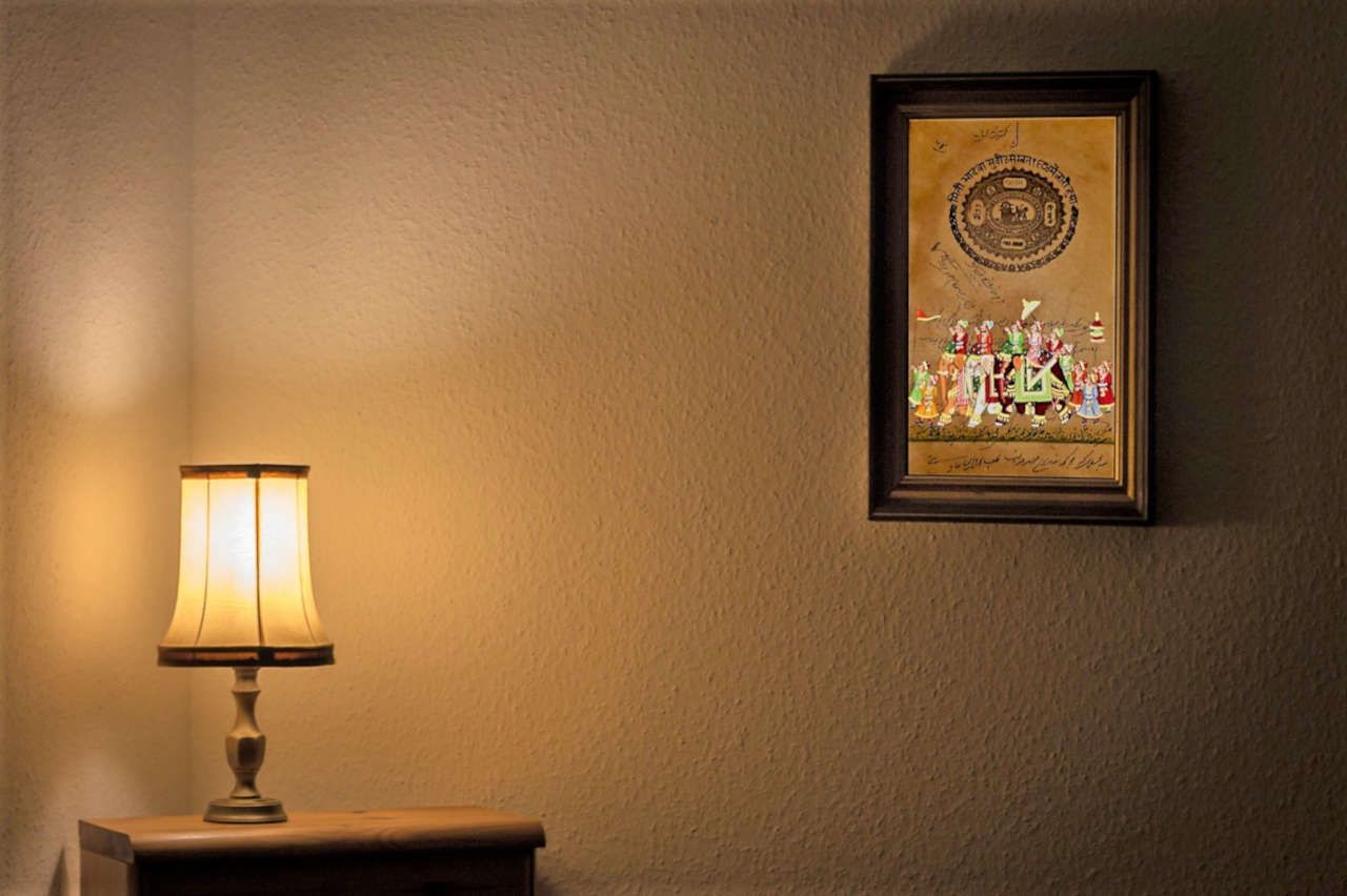 AVIVANA Vintage Stamp Paper Painting in bedroom with mirrored furniture.