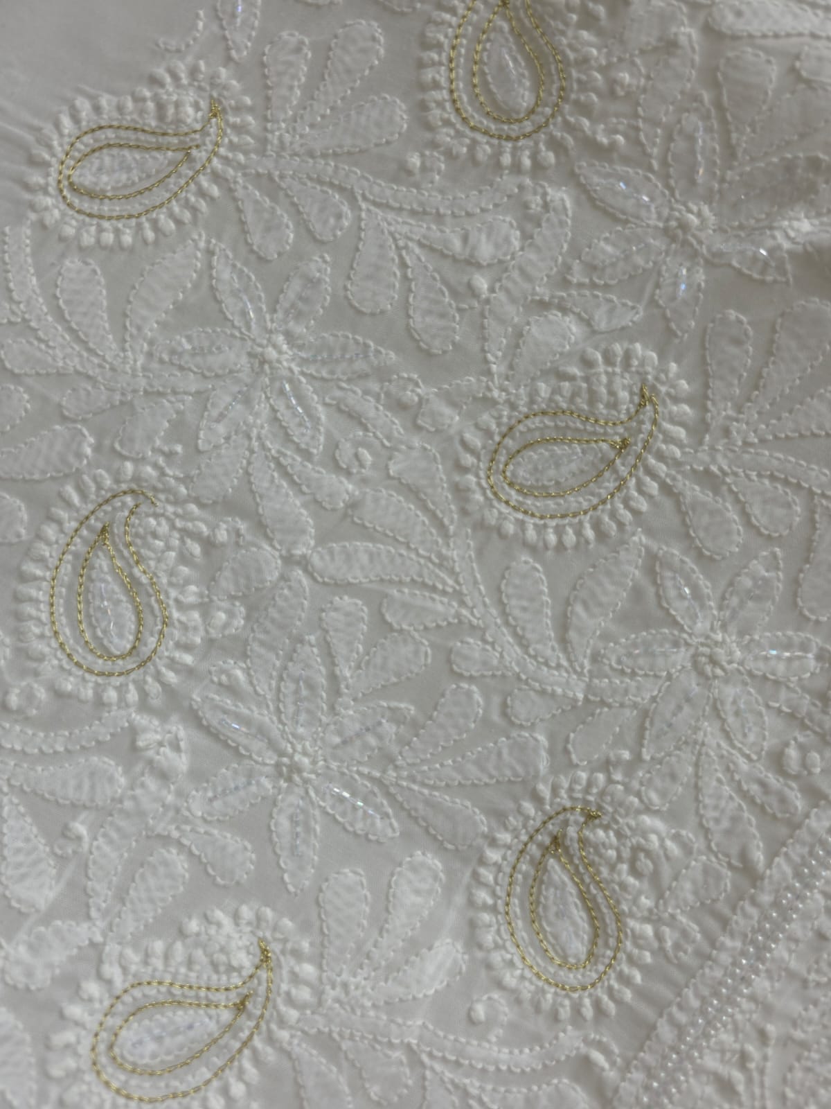 Pristine White suit with exquisite jaal chikan and heavy pearl cutdana