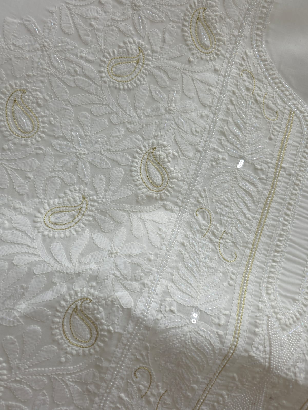 Pristine White suit with exquisite jaal chikan and heavy pearl cutdana