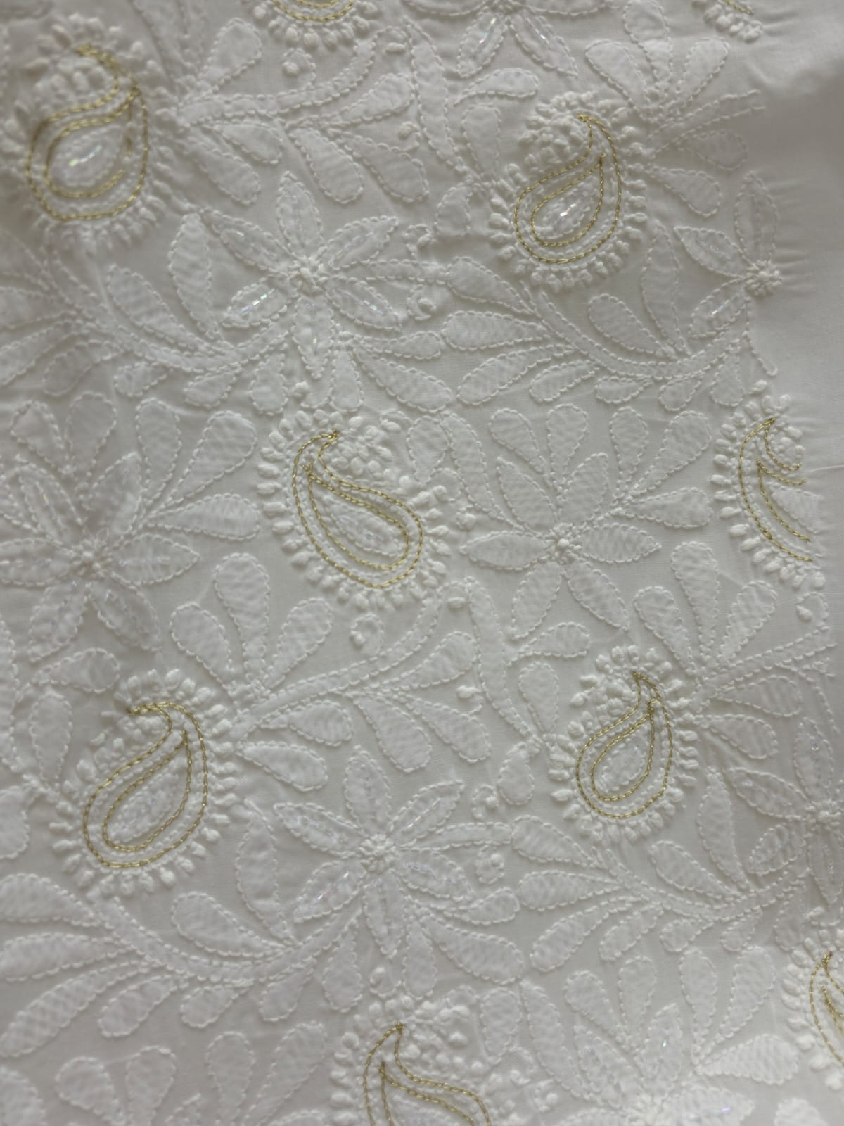 Pristine White suit with exquisite jaal chikan and heavy pearl cutdana