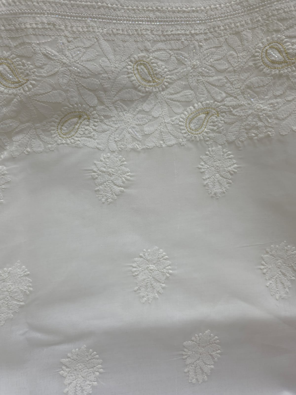 Pristine White suit with exquisite jaal chikan and heavy pearl cutdana