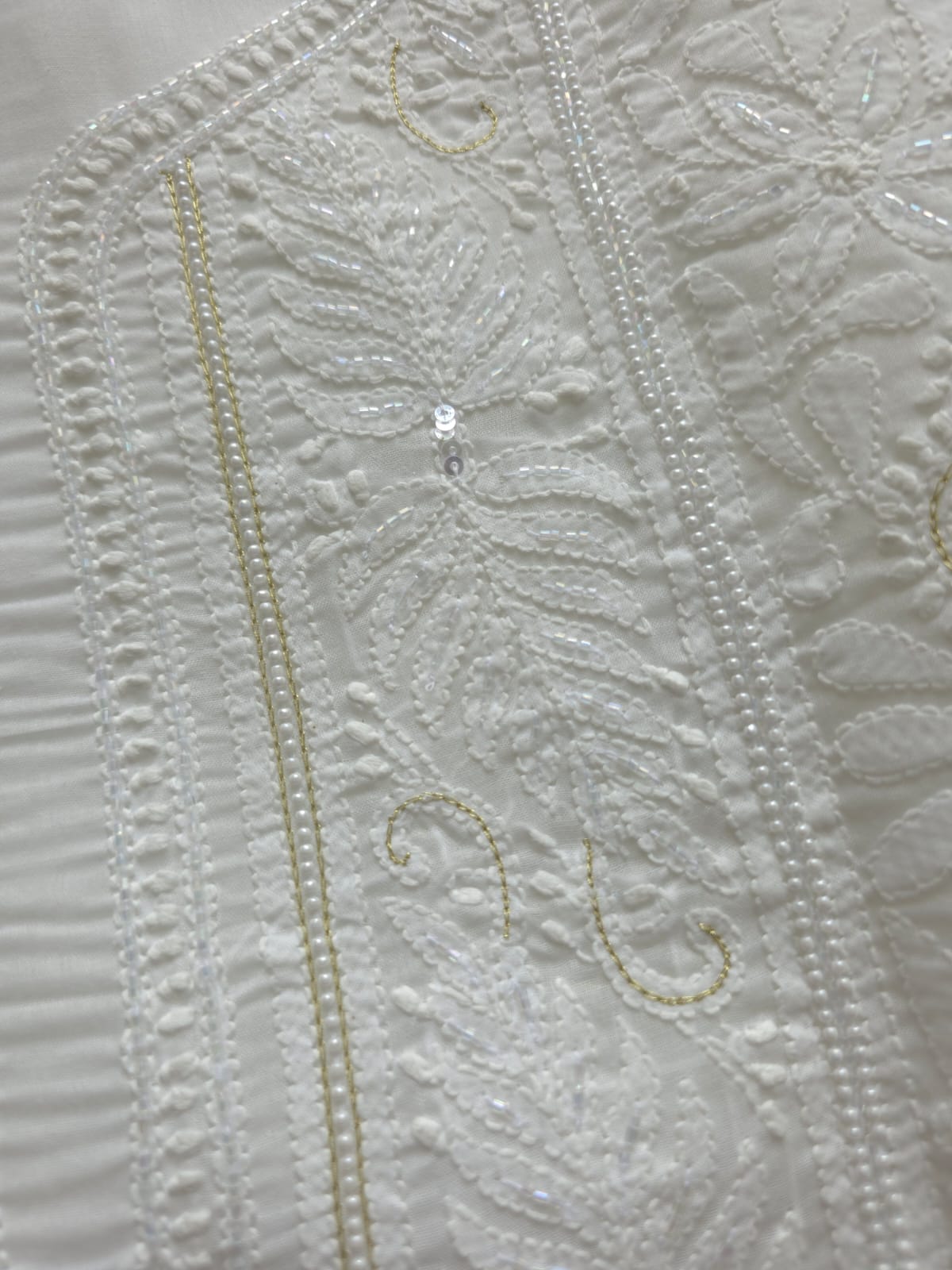 Pristine White suit with exquisite jaal chikan and heavy pearl cutdana