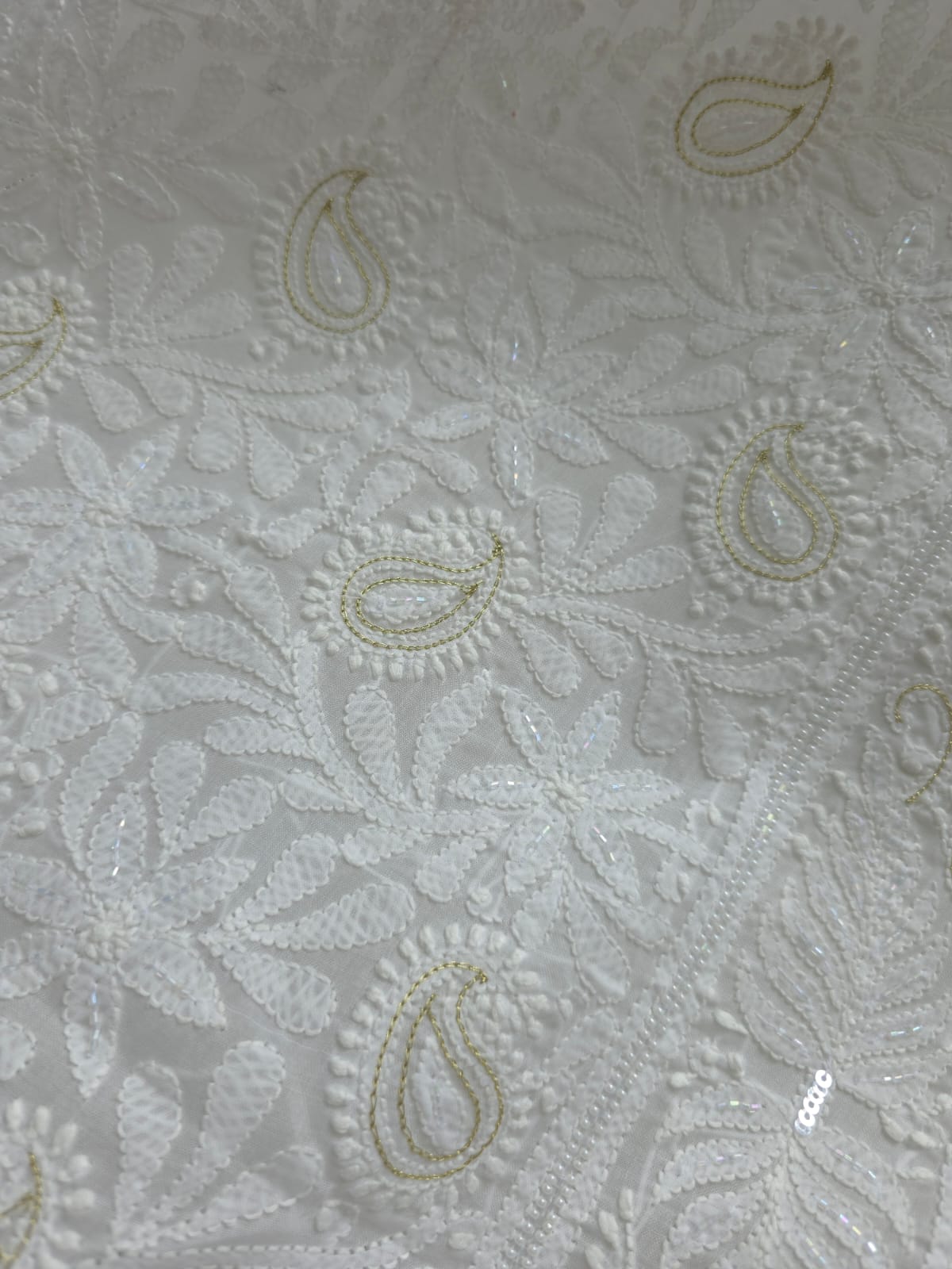 Pristine White suit with exquisite jaal chikan and heavy pearl cutdana