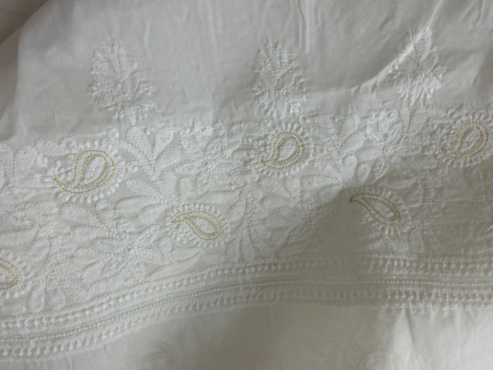 Pristine White suit with exquisite jaal chikan and heavy pearl cutdana