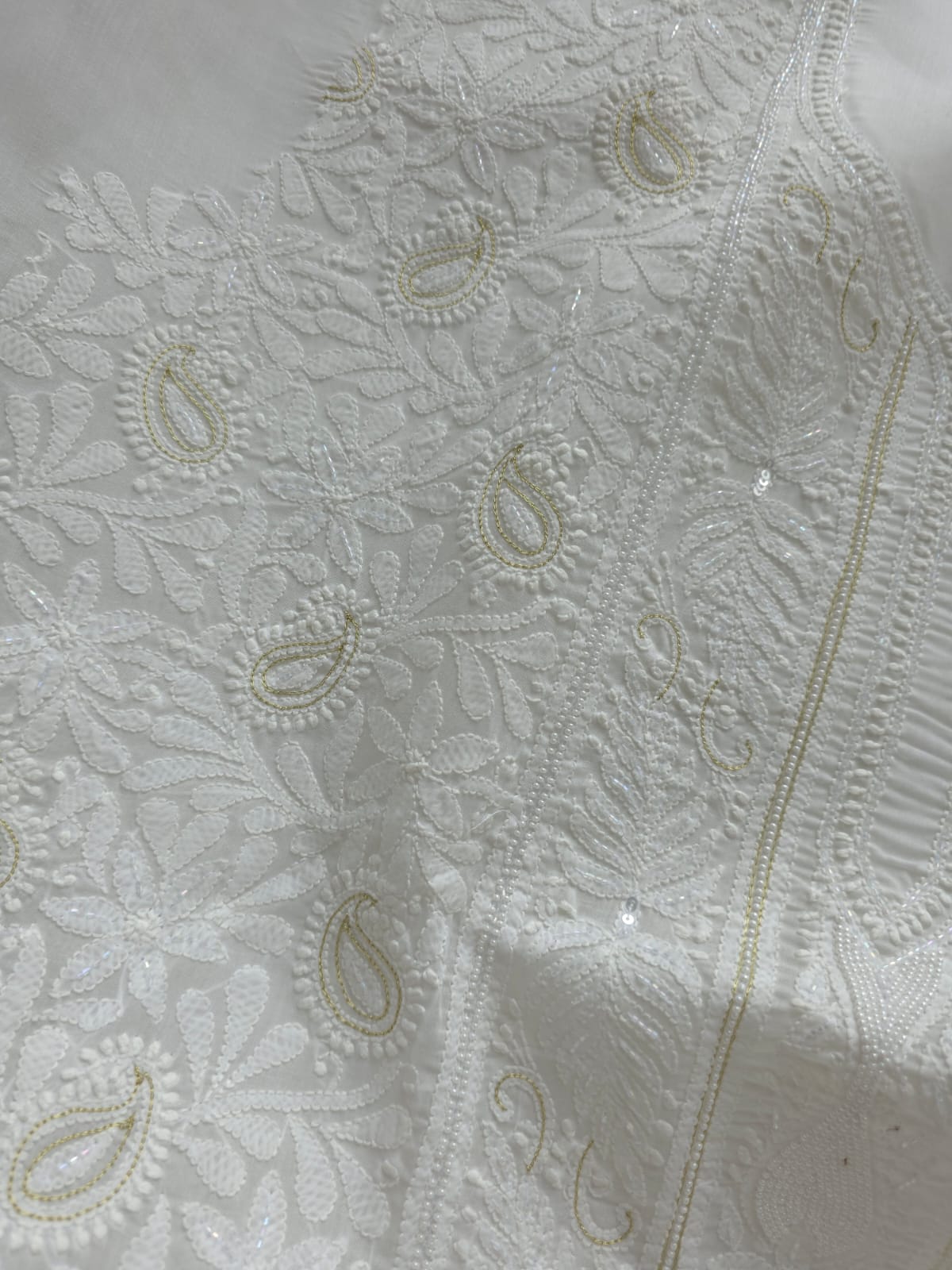 Pristine White suit with exquisite jaal chikan and heavy pearl cutdana