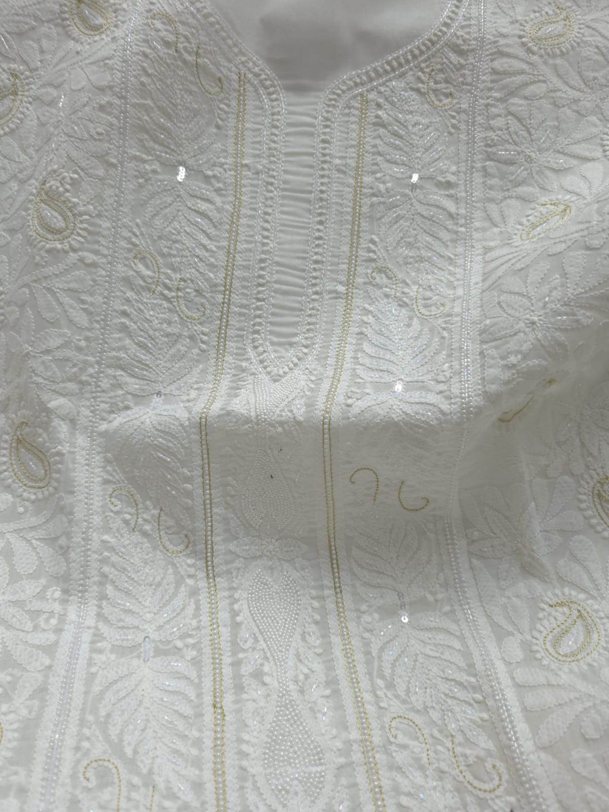 Pristine White suit with exquisite jaal chikan and heavy pearl cutdana