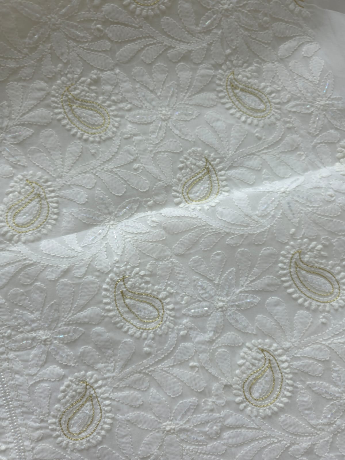 Pristine White suit with exquisite jaal chikan and heavy pearl cutdana