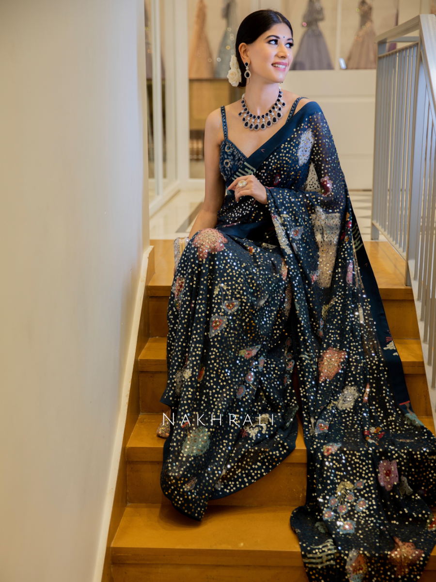 Trendy woman wearing black printed saree with modern style