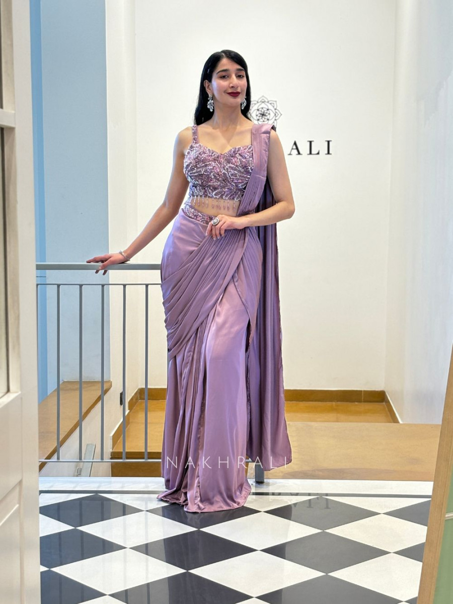 Elegant woman wearing a lavender purple designer saree