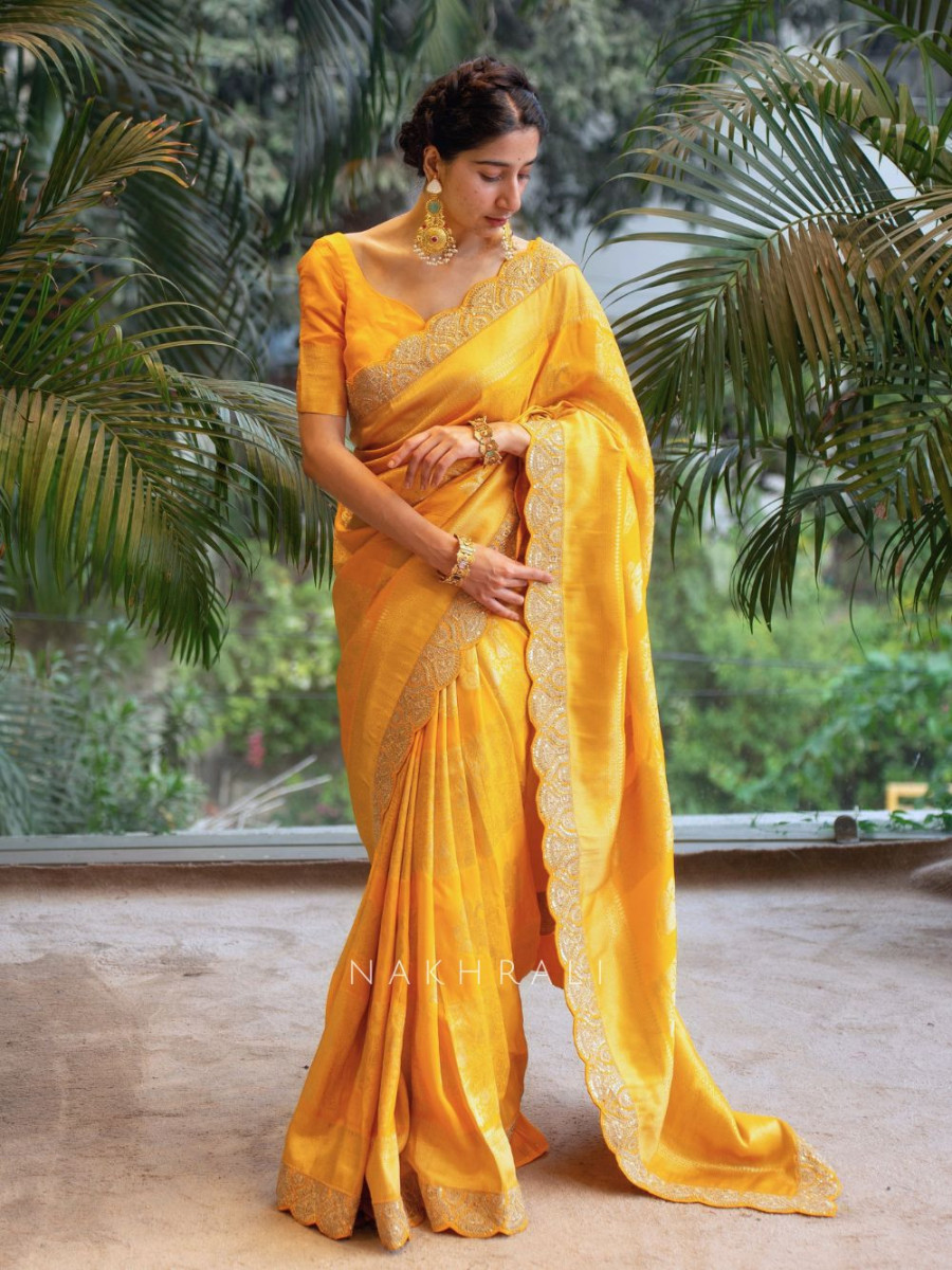 Stylish woman in bright yellow traditional saree