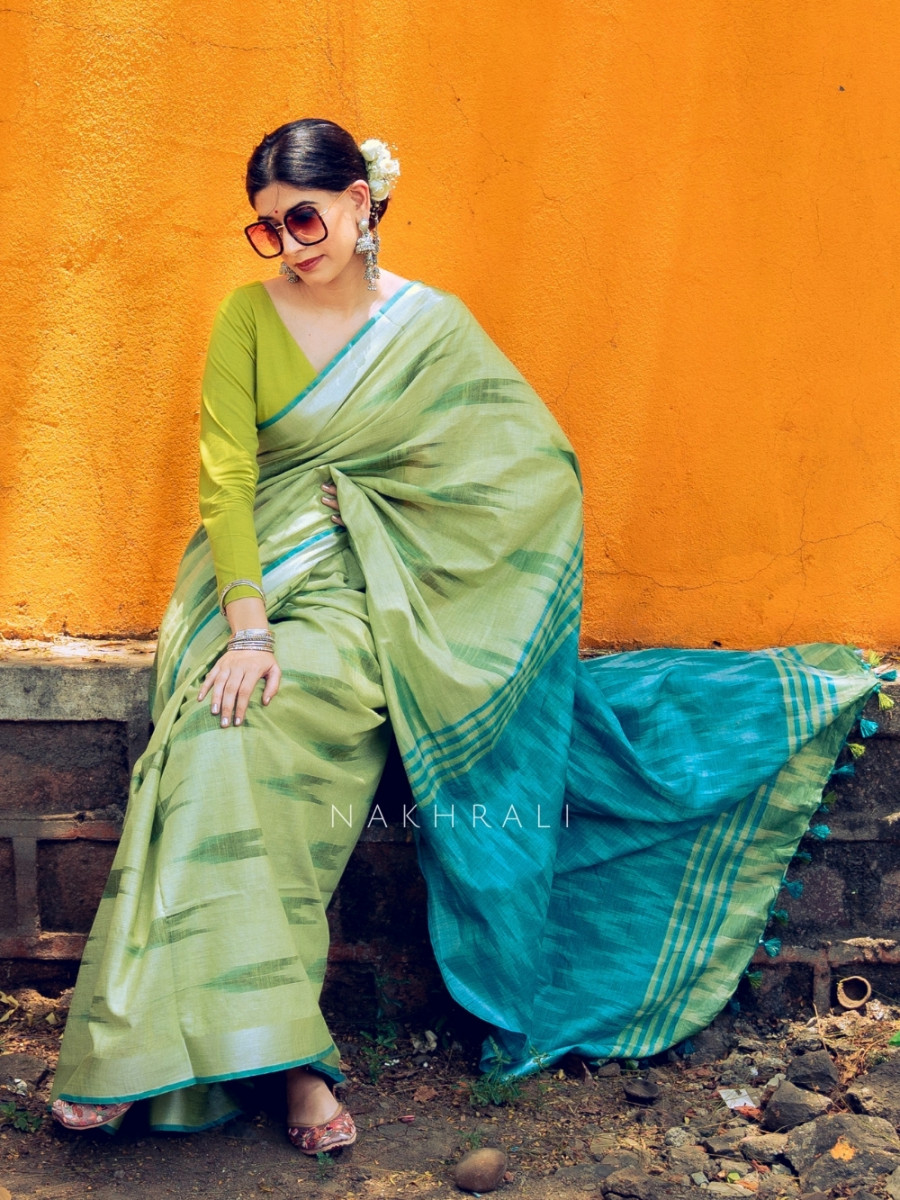 Woman wearing elegant pastel green handloom saree