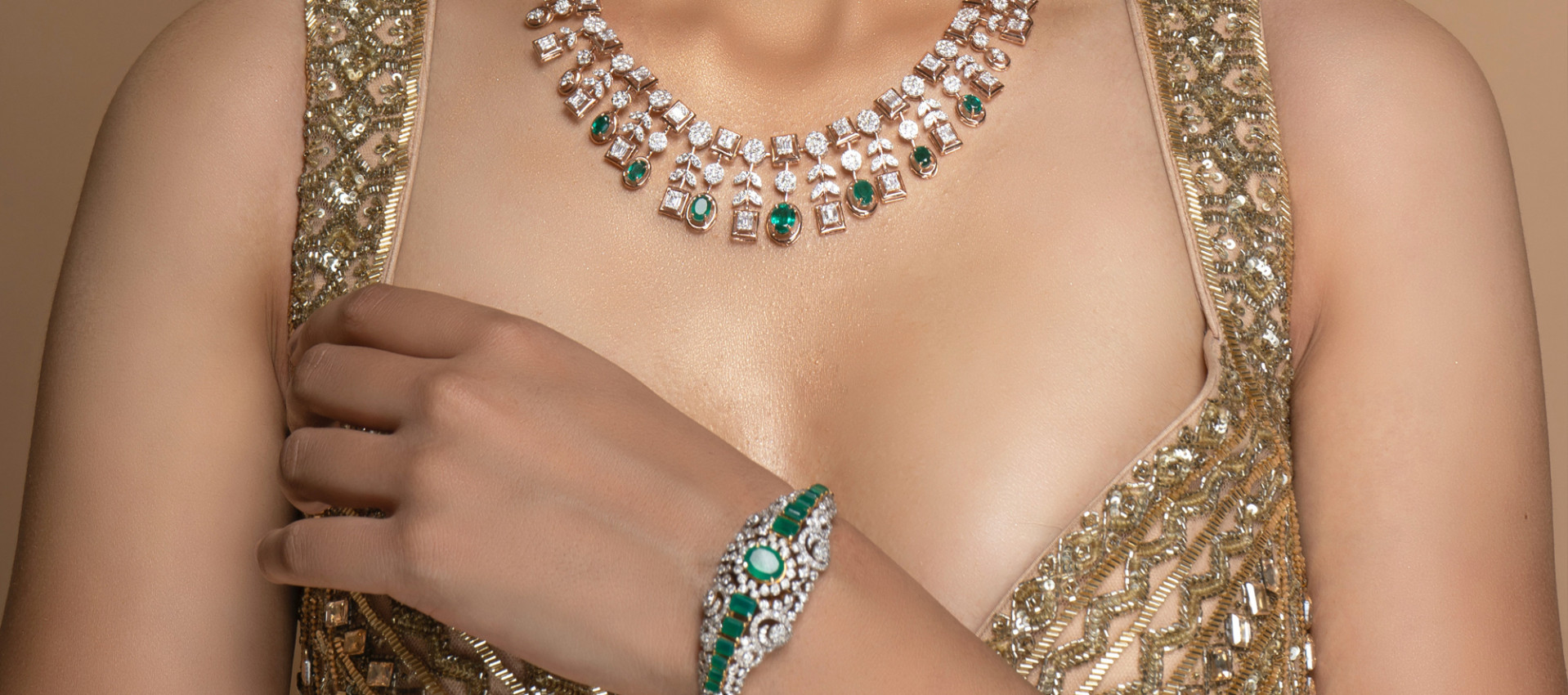 wearing diamond and emerald necklace by the girl