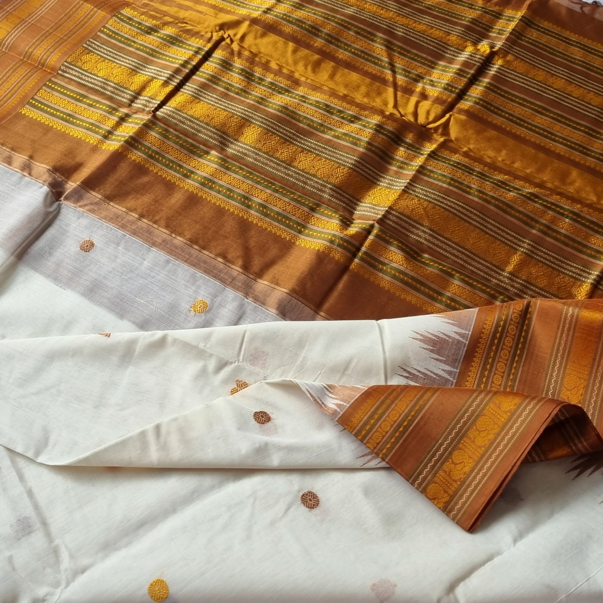 Kanchi Cotton body offwhite with bronze Korvai Silk Borders