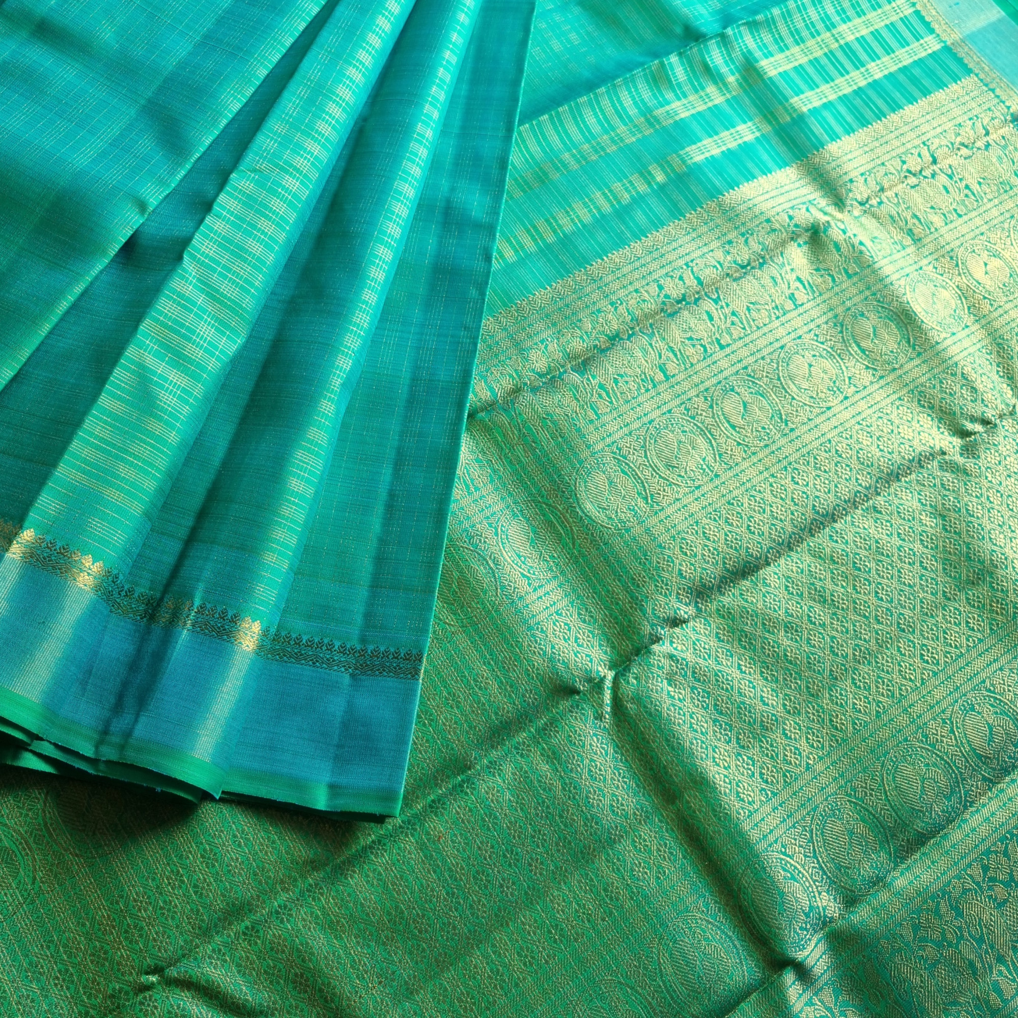 Kanjivaram Silk Splendid shot sea with all over  zari grids