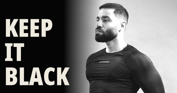 Man in a black Lifters compression t-shirt against a grey studio backdrop, with bold cream text reading "KEEP IT BLACK" on a black panel - blog thumbnail for an article about preventing black gym clothes from fading.