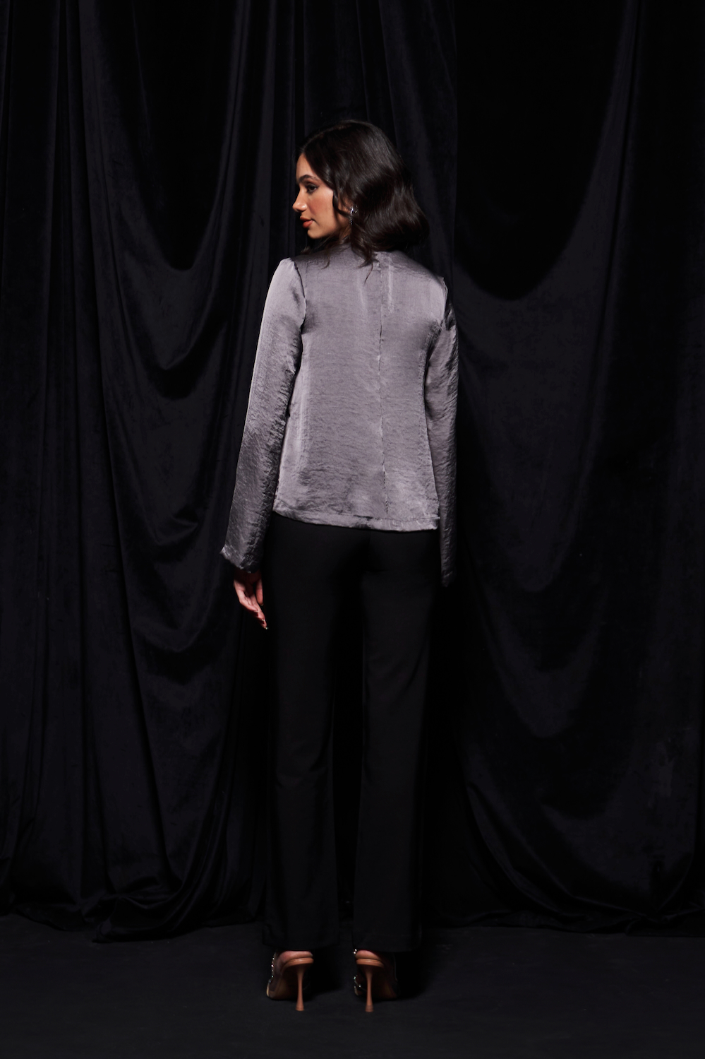 LEILA TANNED SILVER COLOR TEXTURED SATIN WAIST LENGTH LONG SLEEVES TOP WITH PLEAT DETAILING AND ZIP OPENING AT THE BACK