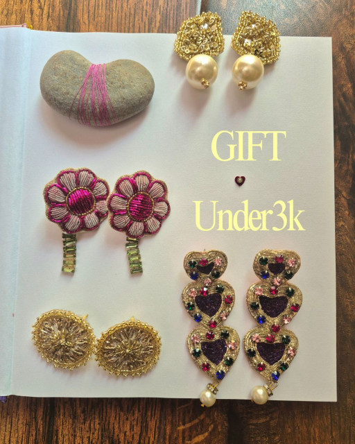 Flat lay of handcrafted embroidered jewelry gifts under ₹3,000, featuring artisan statement earrings styled as a gifting collection.