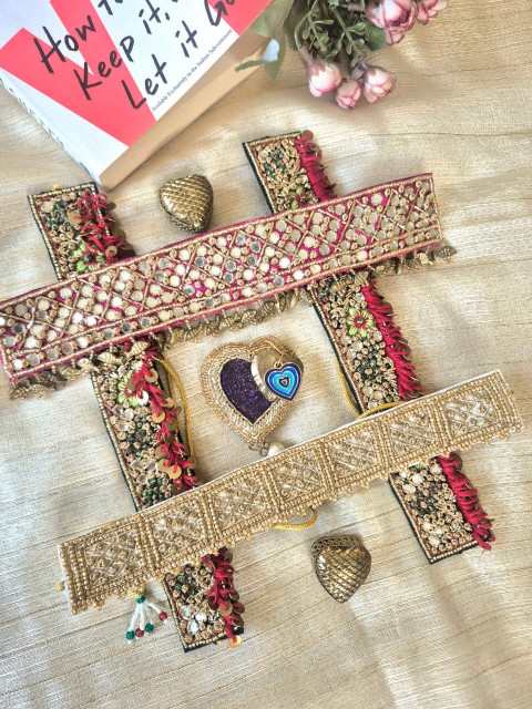 Handcrafted embroidered choker jewelry and heart statement pieces displayed in a decorative flat lay.