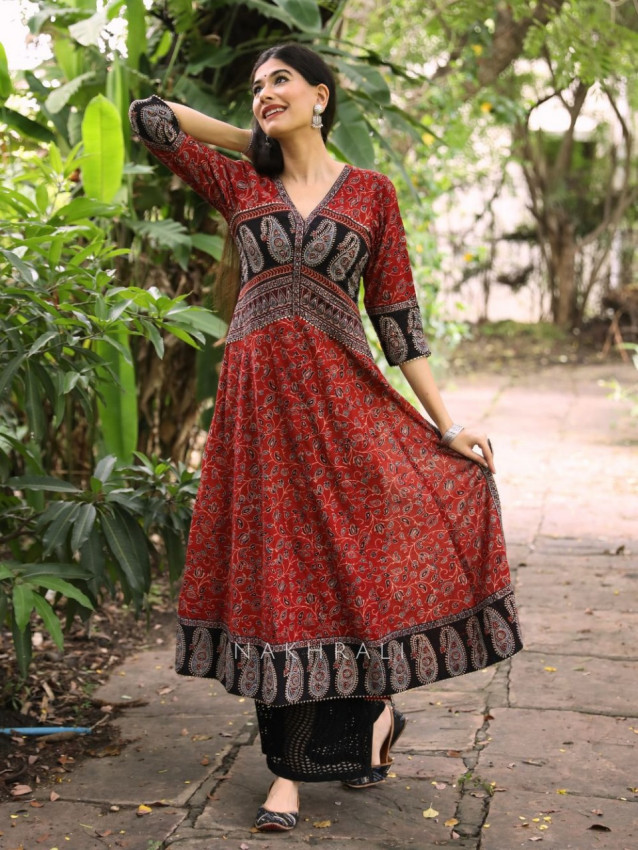 Woman wearing a straight kurta set with palazzo in festive color