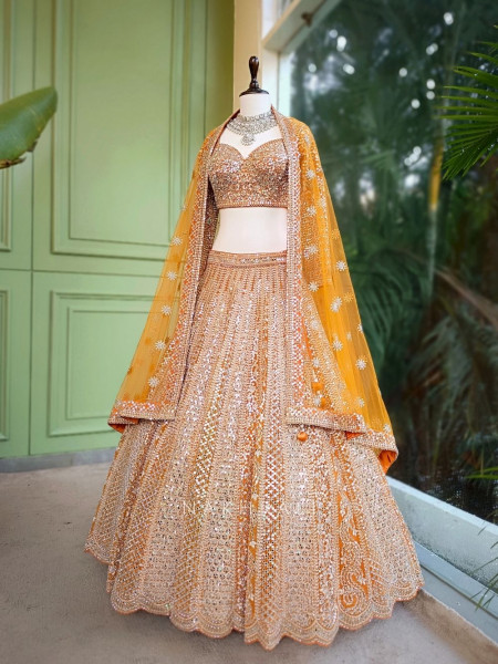 Sitara Orange Net Lehenga with Mirror, Zari and Bead Embellishments Sitara Orange Net Lehenga with Mirror, Zari and Bead Embellishments