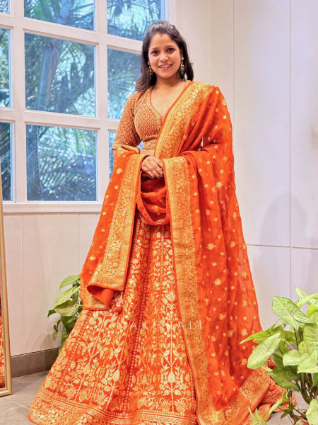 Vedhika Glint Orange Brocade Lehenga with Zari and Sequin Work