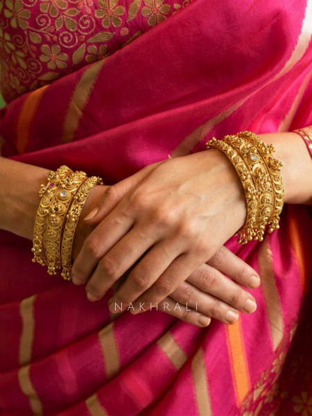 Hemvritta Golden Bangle Set With Temple Motif and Beaded Fringe Detail