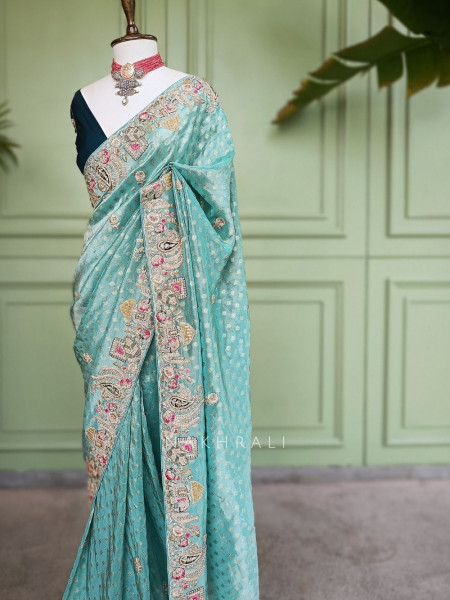 Mrig-sangam Firozi Tissue Saree with Hand Embroidered Paisley Border