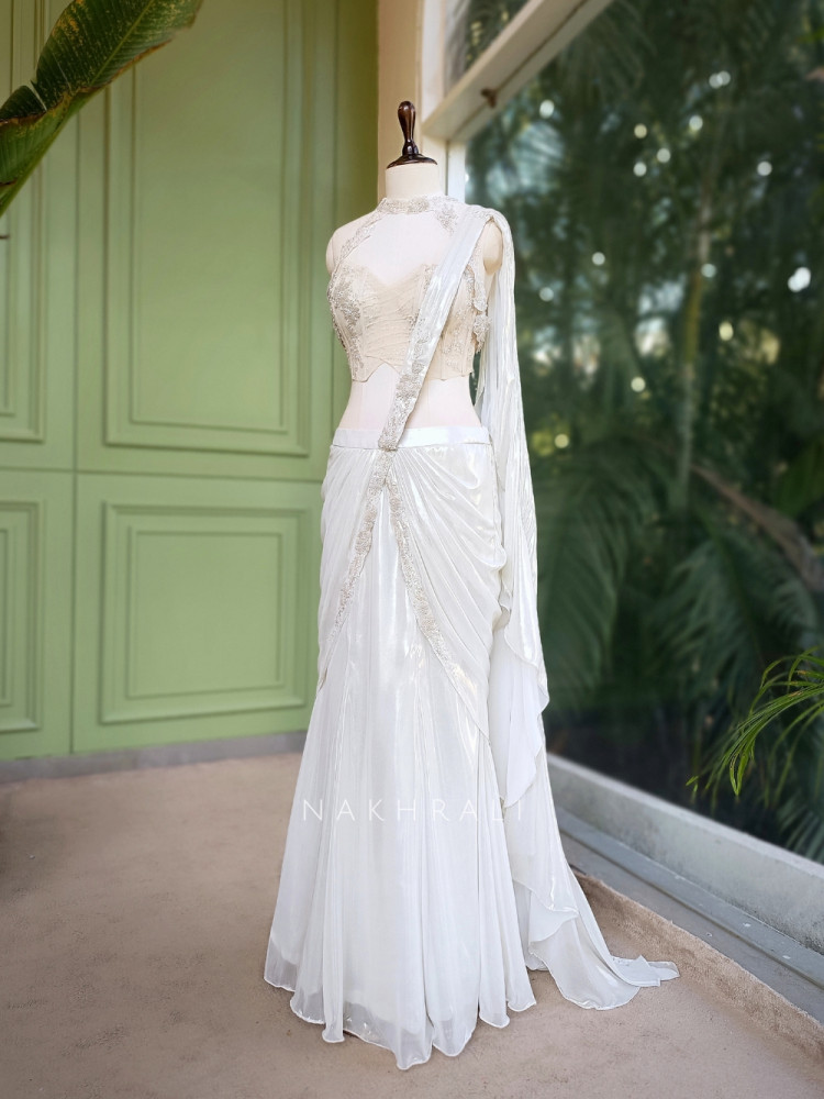 Structured Ivory Drape An ivory organza drape saree featuring delicate pearl and sequin ...