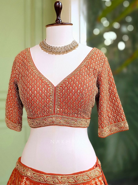 Vedhika Glint Orange Brocade Lehenga with Zari and Sequin Work