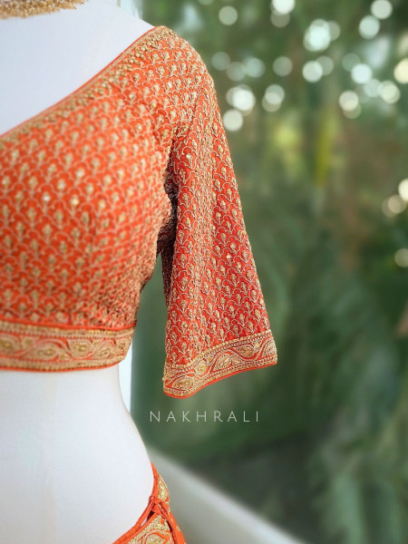 Vedhika Glint Orange Brocade Lehenga with Zari and Sequin Work