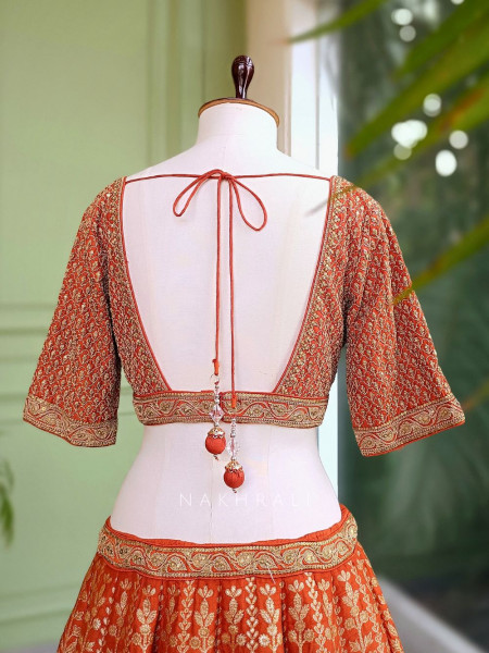 Vedhika Glint Orange Brocade Lehenga with Zari and Sequin Work