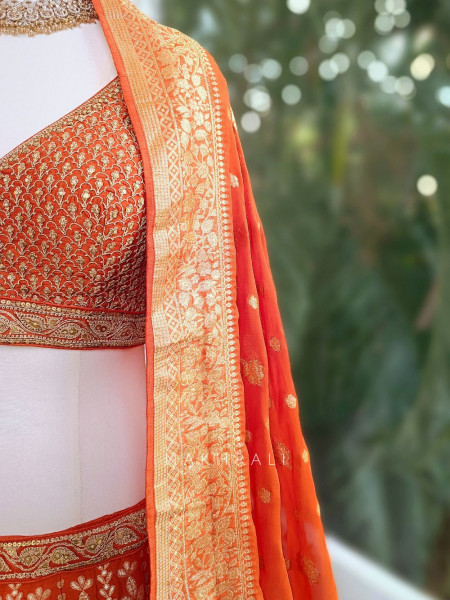 Vedhika Glint Orange Brocade Lehenga with Zari and Sequin Work