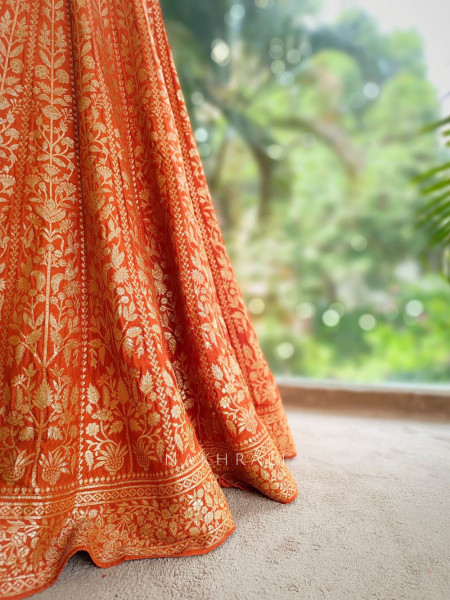 Vedhika Glint Orange Brocade Lehenga with Zari and Sequin Work