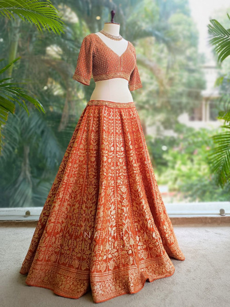 Vedhika Glint Orange Brocade Lehenga with Zari and Sequin Work