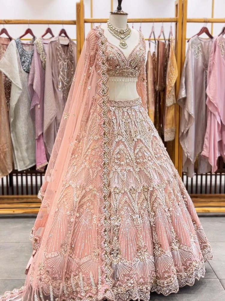 Image of Cosmic Peach Net Lehenga with Beads Sequin and Pearl Work