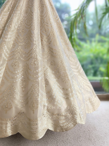 Kanakriti Beige Banarasi Brocade Silk Lehenga Set With Jewel Embellished Halter & Zari Work