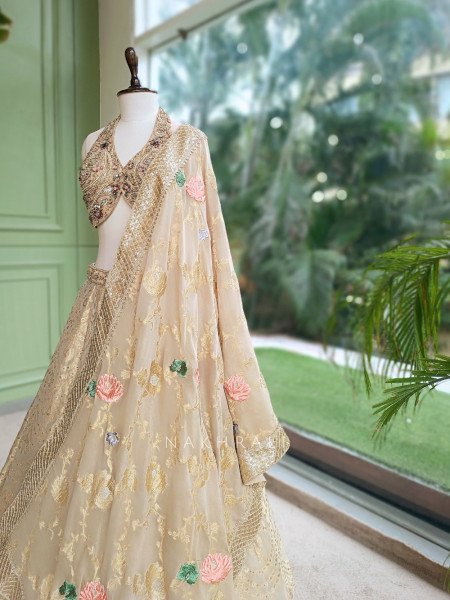 Kanakriti Beige Banarasi Brocade Silk Lehenga Set With Jewel Embellished Halter & Zari Work