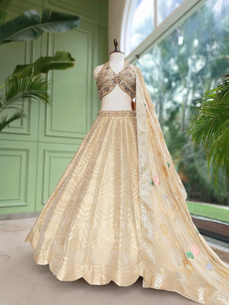Kanakriti Beige Banarasi Brocade Silk Lehenga Set With Jewel Embellished Halter & Zari Work