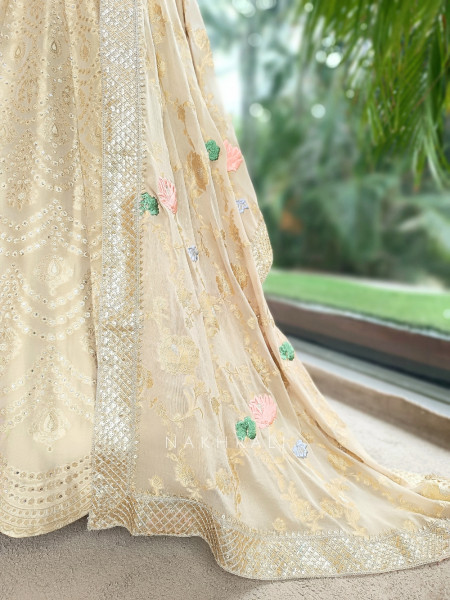 Kanakriti Beige Banarasi Brocade Silk Lehenga Set With Jewel Embellished Halter & Zari Work
