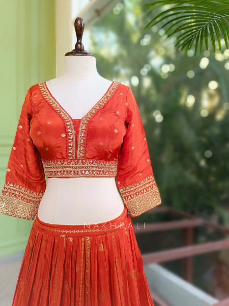 Kavira Orange Lehenga with Woven Dupatta and Subtle Zari Work