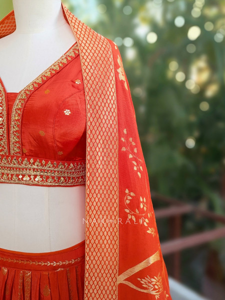 Kavira Orange Lehenga with Woven Dupatta and Subtle Zari Work