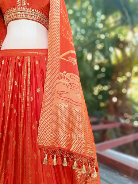 Kavira Orange Lehenga with Woven Dupatta and Subtle Zari Work