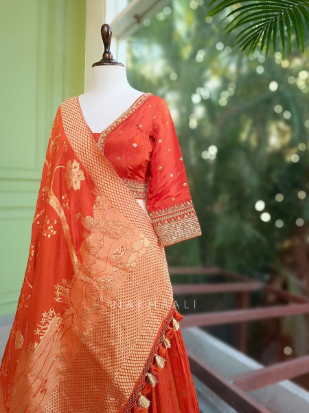 Kavira Orange Lehenga with Woven Dupatta and Subtle Zari Work