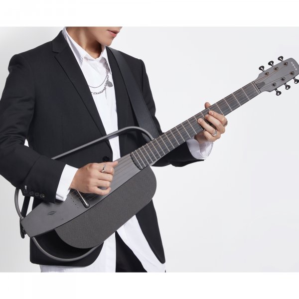 Musician travelling with a compact smart guitar and carry case