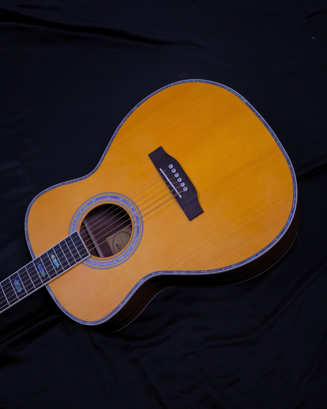 SQOE OM40B Solid Spruce Top OM Acoustic Guitar Vintage Yellow - body on dark background