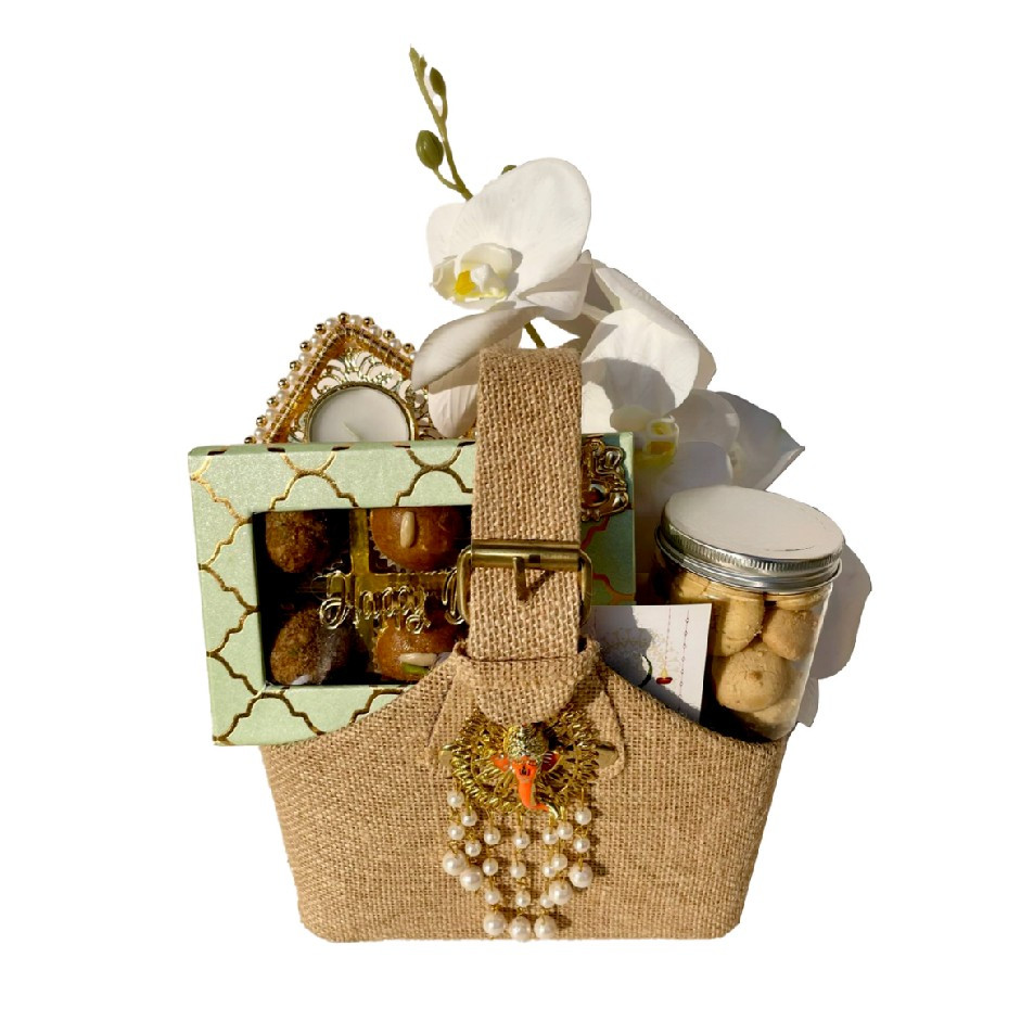Premium Jute Basket with Assorted Nutty Laddus, Nankhatais or Peri-Peri Cashews Jar & Elephant Diya – Floral Decor | Festive Gift UAE