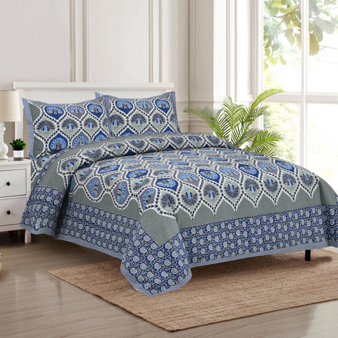 Azure petal teardrop Jaipuri block-print king-size cotton bedsheet 100108 laid on bed with two matching pillow covers and printed border